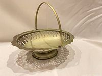 Oblique view showing full bowl, footed base, swing handle raised