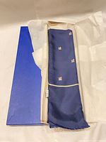 Scarf folded inside blue box with tissue