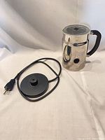 Milk frother with lid and power base laid out