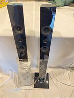 Front view of both Samsung PS-ET3-1 speakers showing drivers and bases