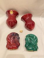 Front view of four glazed wall pocket vases