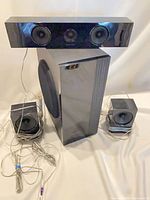 Front view of subwoofer, centre channel and two satellites with cables