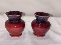 Front view of both red glazed vases