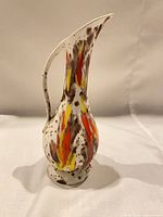Full side view of ceramic pitcher-style vase showing handle and drip glaze
