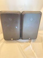 Front view of both JBL Control speakers with grilles and logo visible