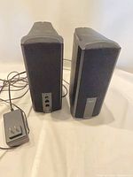 Front view of both Yamaha YST-M15 speakers and wired control