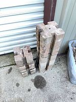 Stack of 8 concrete pier blocks showing overall quantity and condition