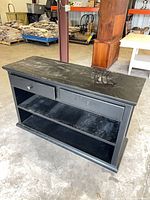 front view showing drawers, open shelves, top scratches