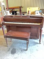 Front view of Cable upright console piano with bench