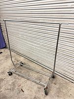 Full view of chrome garment rack against backdrop