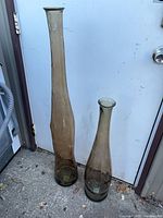 Both smoky amber glass floor vases front view showing height difference and overall shape