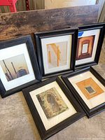 All five framed prints grouped on floor