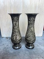 Front view of both etched metal vases