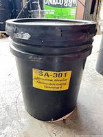 Front view of black pail with yellow SA-301 label