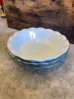 Stack showing three pie plates, highlighting scalloped edges and color difference