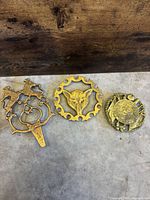 overview of three brass trivets