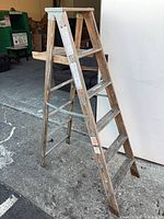 Full view of wood A-frame ladder left side