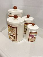 Group shot of four ceramic canisters with lids