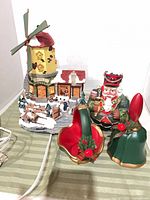 Group view of windmill building, nutcracker and two bells