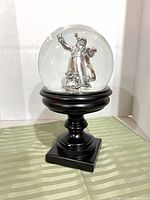 Snow globe on pedestal front view