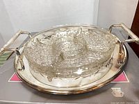 Glass divided relish dish seated on metal tray with handles