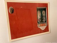 Full view of framed photographic print showing red wall, window motif, off-white border