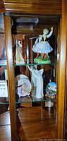 Figurines and plates displayed in cabinet