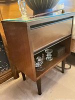 Nightstand showing drawer, shelf, glass top protector, tapered legs
