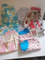 Five aprons laid out showing variety of prints