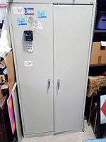 Front view of closed gray metal cabinet, showing overall exterior