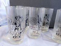 Group of four glasses showing Minute Man, Charlemont Indian, Paul Revere and unidentified scene