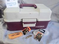 Closed Woodstream tackle box with several tackle items displayed in front