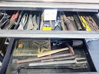 Drawer with assorted pliers, wrenches, files, Allen keys visible