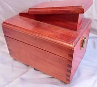 angled view showing wood shoeshine box, dovetail joints, footrest top