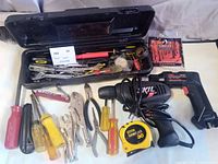 Overall lot showing toolbox, cordless drill, tape measure and assorted tools