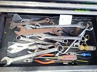 Drawer view showing assorted wrenches, pliers and screwdrivers