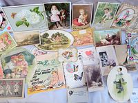 Overall spread of 25+ vintage greeting cards laid out