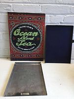 Front view showing Ocean Blend Tea sign, aluminum tray and blue tray
