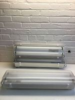 Two fixtures open showing dual fluorescent tube capacity