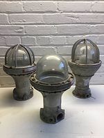 Group shot of three explosion-proof lights showing overall condition and design