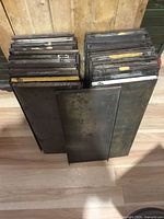 Stacked rectangular metal trays showing quantity and general condition