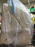 Stacked white quilted memory-foam wedges in plastic bag showing Lunix tags