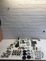 Overview of all cabinet hardware laid out on table