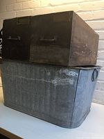 Galvanized basin stacked under two wooden drawers