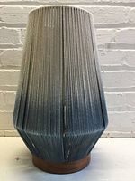 Front view of rope-wrapped lantern table lamp on wooden base