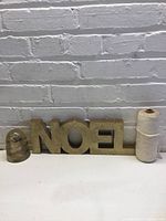 All three items together: NOEL sign, glass insulator, string spool