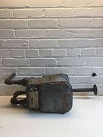 Gas meter front view showing attached pipes and dial housing