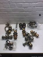 Overview of multiple door knob and lock sets on table