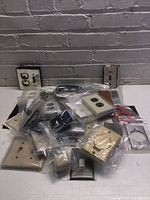 Pile of assorted cover plates in bags