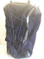 Front view of rolling duffel with open zipper and interior bungee cords